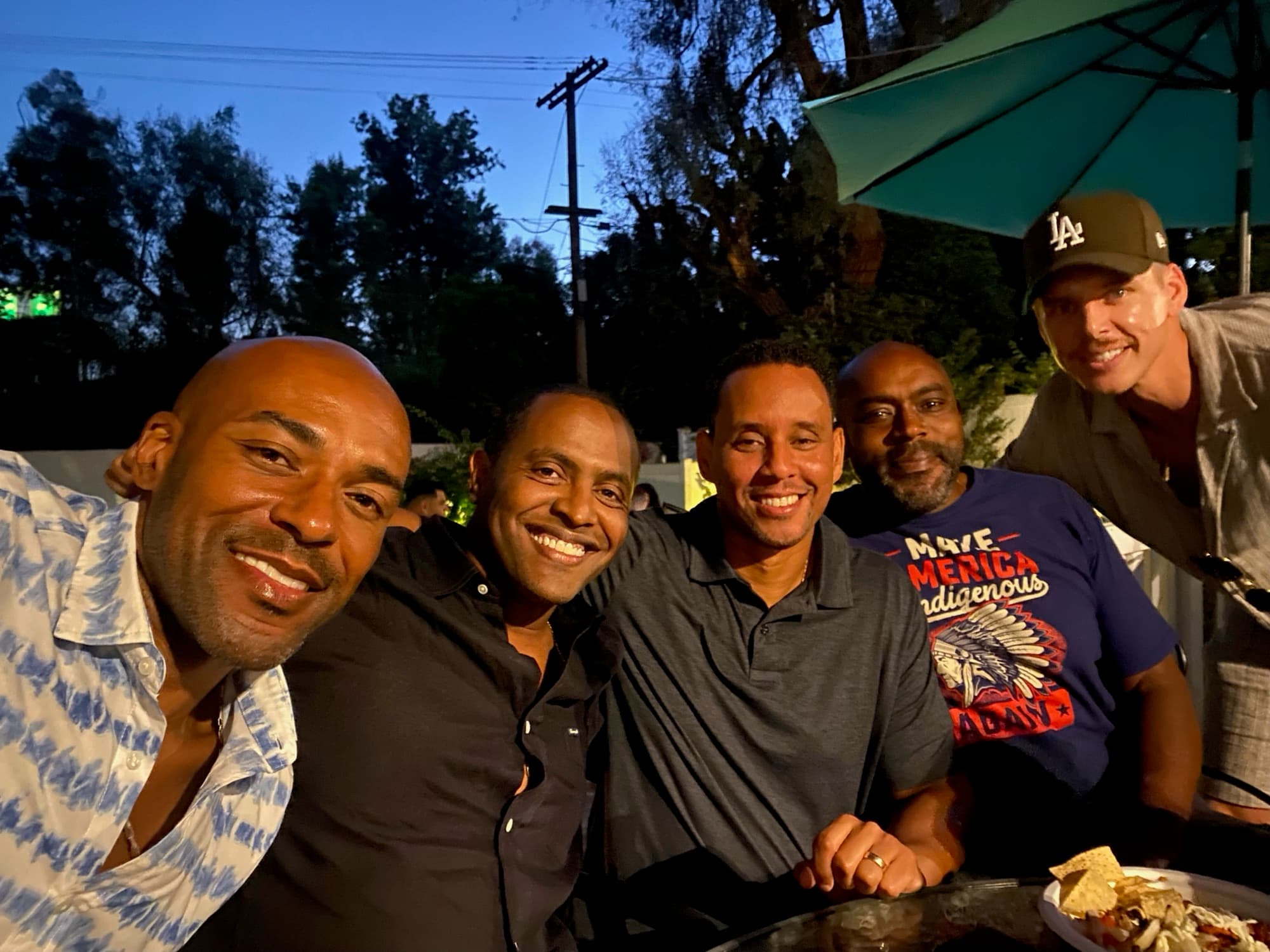 Men gathered together outdoors at night
